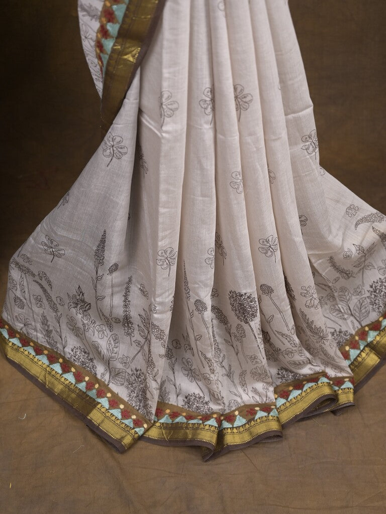 Maheshwari fancy saree in white color with allover prints & zari border with short pallu and contrast blouse