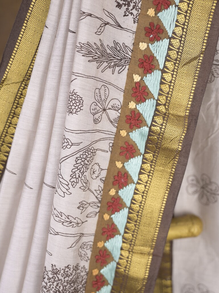 Maheshwari fancy saree in white color with allover prints & zari border with short pallu and contrast blouse
