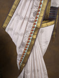 Maheshwari fancy saree in white color with allover prints & zari border with short pallu and contrast blouse