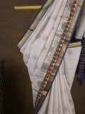 Maheshwari fancy saree in white color with allover prints & zari border with short pallu and contrast blouse