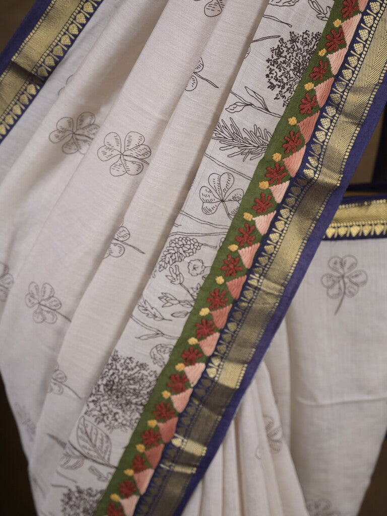 Maheshwari fancy saree in white color with allover prints & zari border with short pallu and contrast blouse