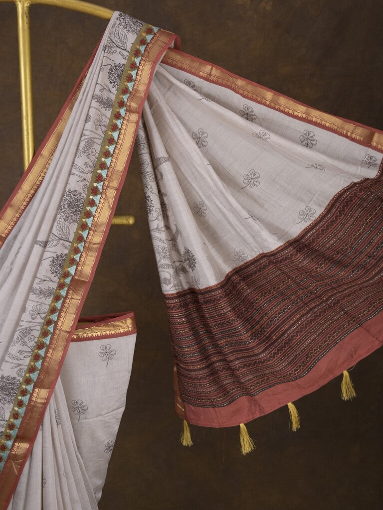 Maheshwari fancy saree in white color with allover prints & zari border with short pallu and contrast blouse