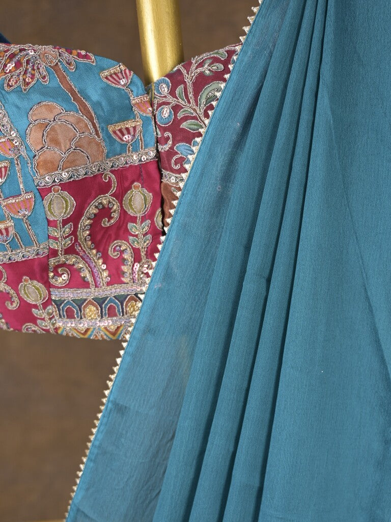 Blue color chinnon plain fancy saree with fancy border and embroidery stitched blouse
