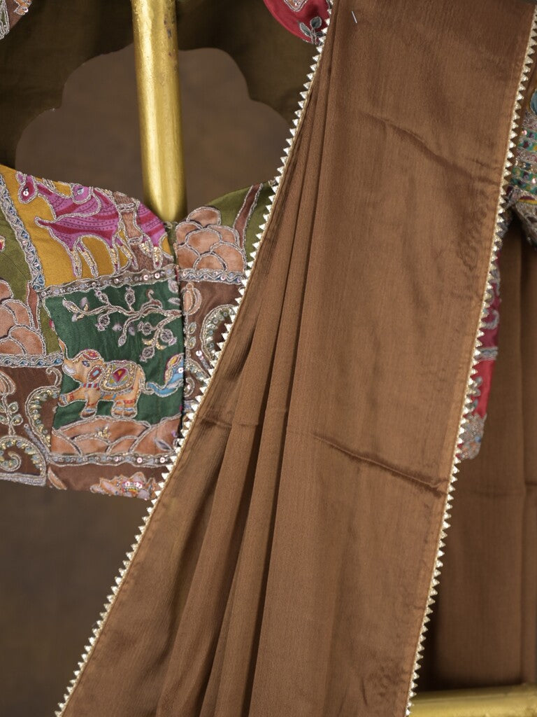 Brown color chinnon plain fancy saree with fancy border and embroidery stitched blouse