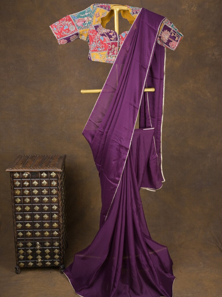 Purple color chinnon plain fancy saree with fancy border and embroidery stitched blouse