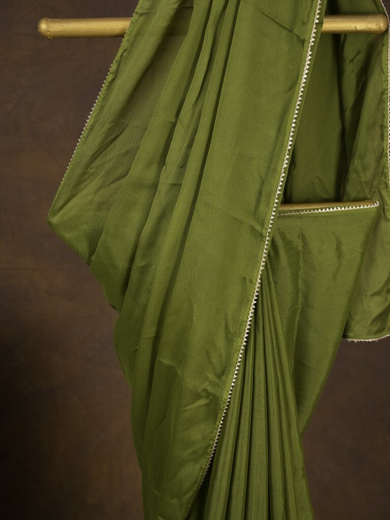 Green color chinnon plain fancy saree with fancy border and embroidery stitched blouse