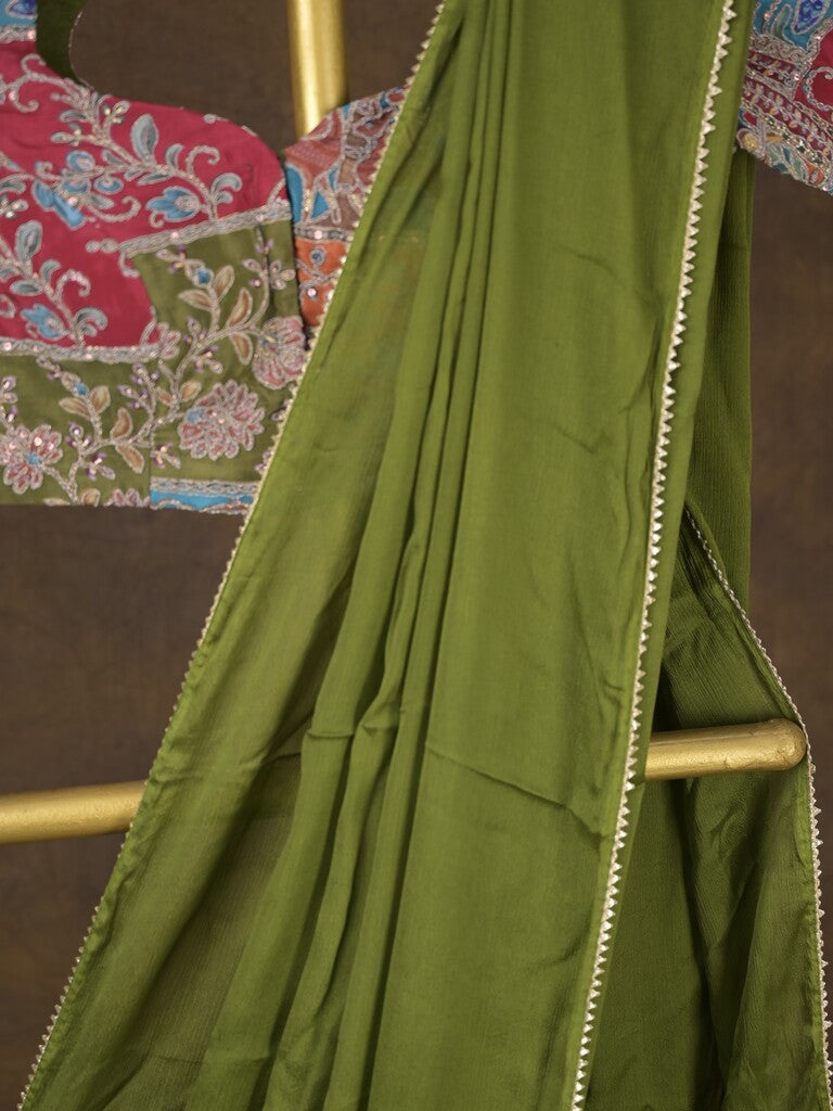 Green color chinnon plain fancy saree with fancy border and embroidery stitched blouse