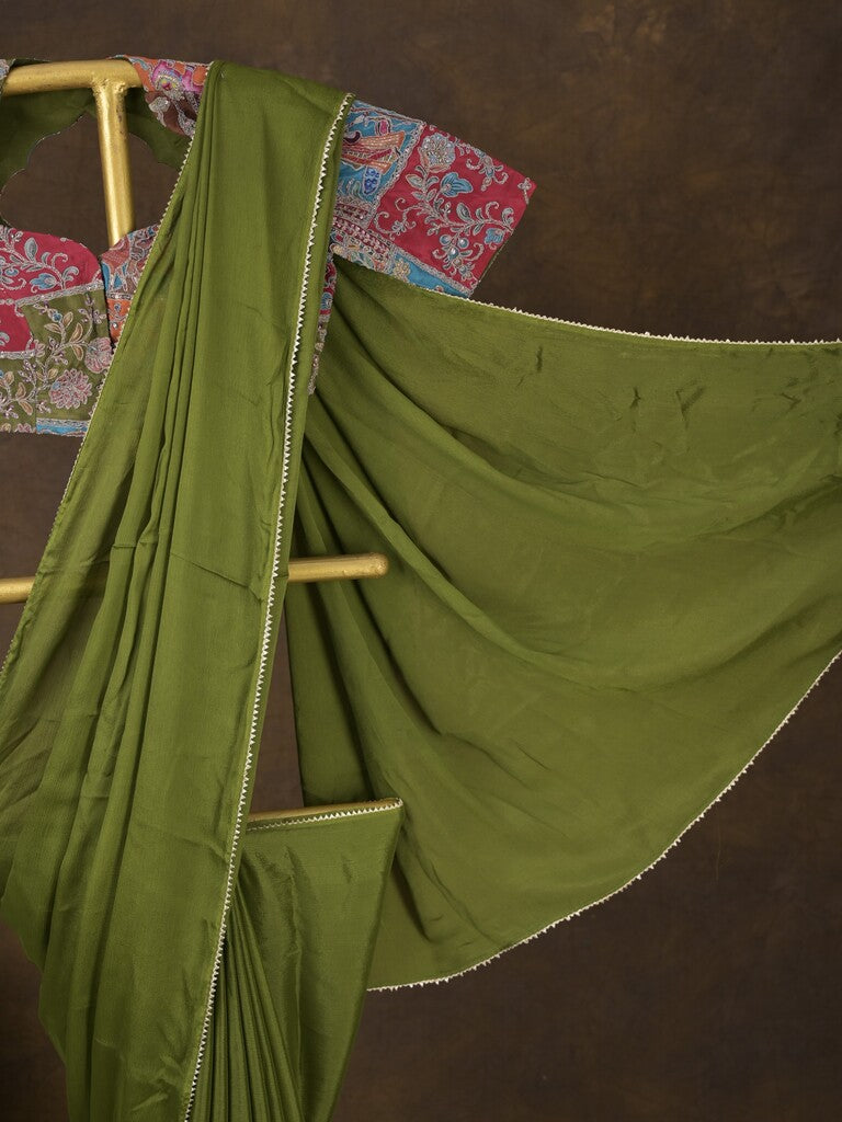 Green color chinnon plain fancy saree with fancy border and embroidery stitched blouse