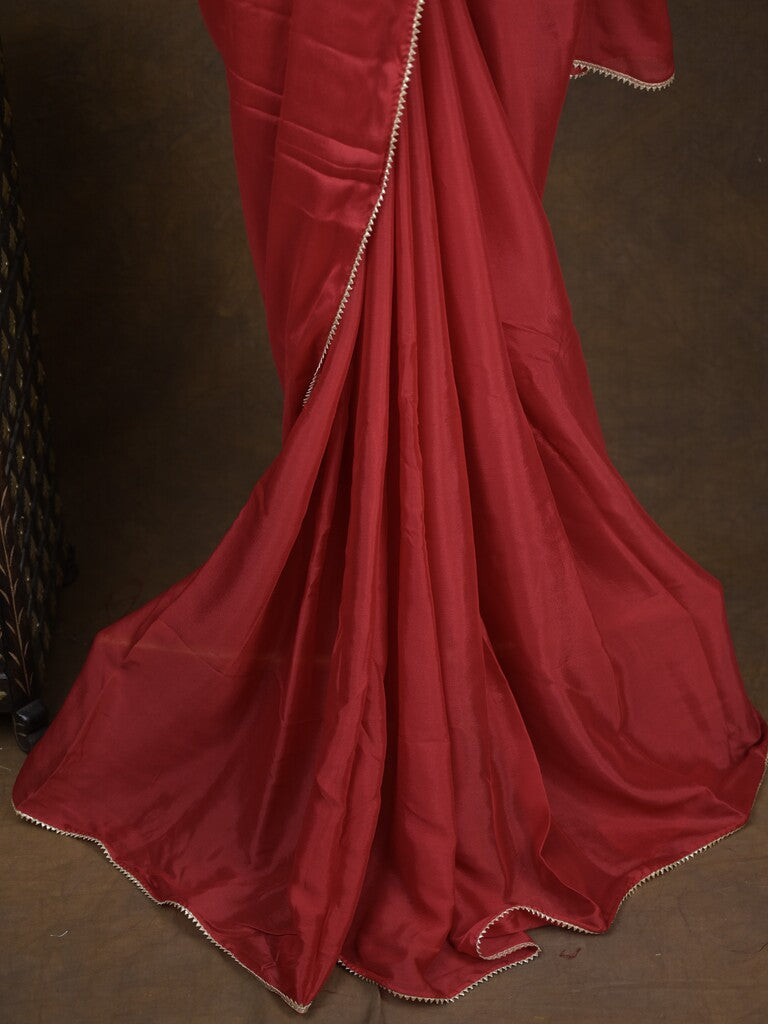 Red color chinnon plain fancy saree with fancy border and embroidery stitched blouse