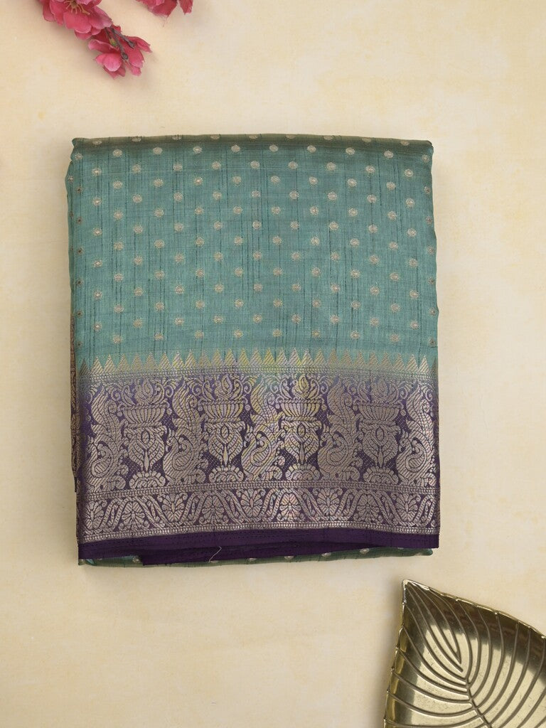 Dupion fancy saree in lux green color allover zari motifs & zari border with zari pallu and attached contrast blouse