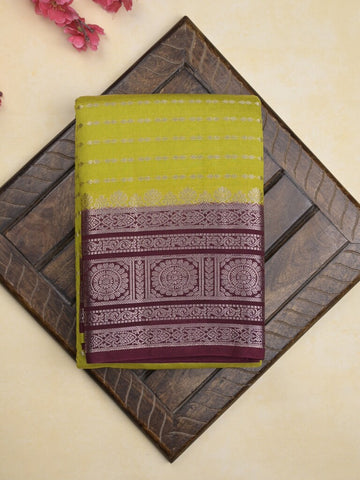 Banaras fancy saree in parrot green color allover zari stripes & zari border with zari pallu and attached contrast blouse