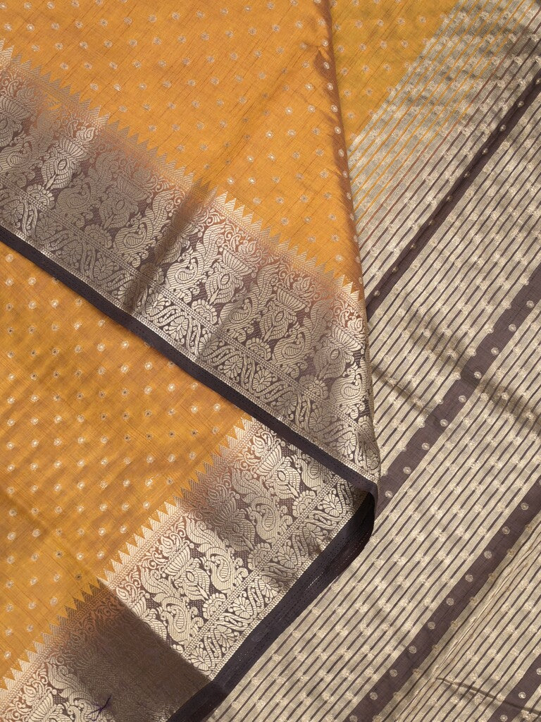 Dupion fancy saree in golden yellow color allover zari motifs & zari border with zari pallu and attached contrast blouse