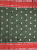 Banaras fancy saree in bottle green color allover zari motifs & zari border with brocade pallu and attached blouse