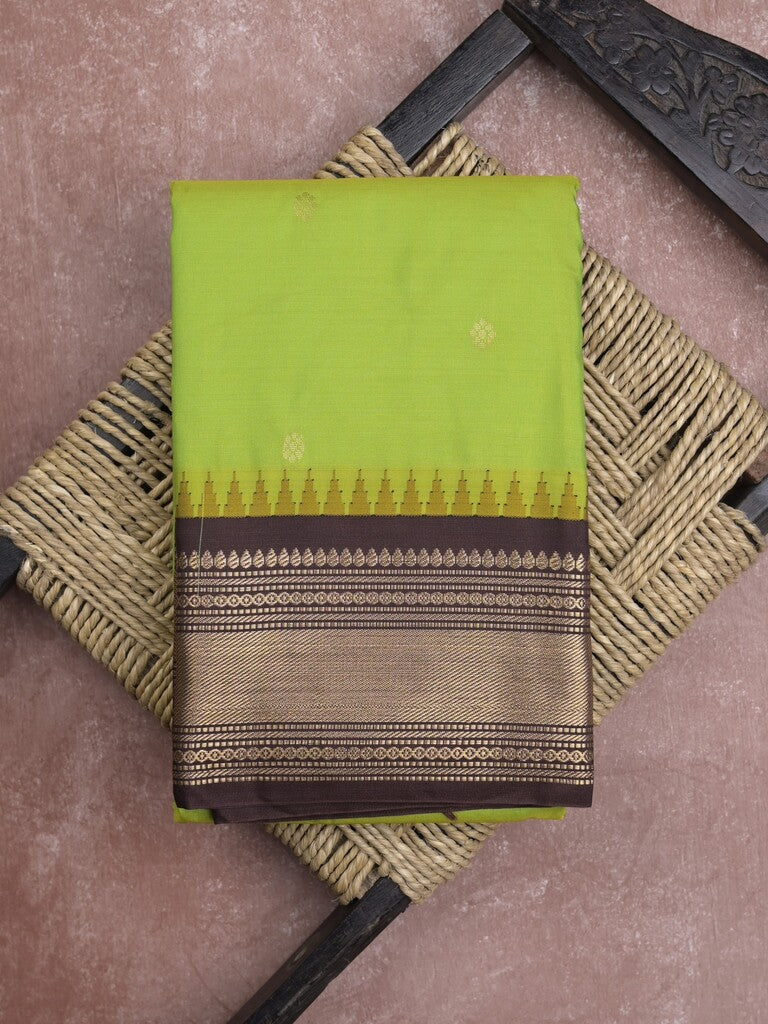 Gadwal pattu saree in parrot green color allover zari motifs & zari border with rich pallu and plain blouse