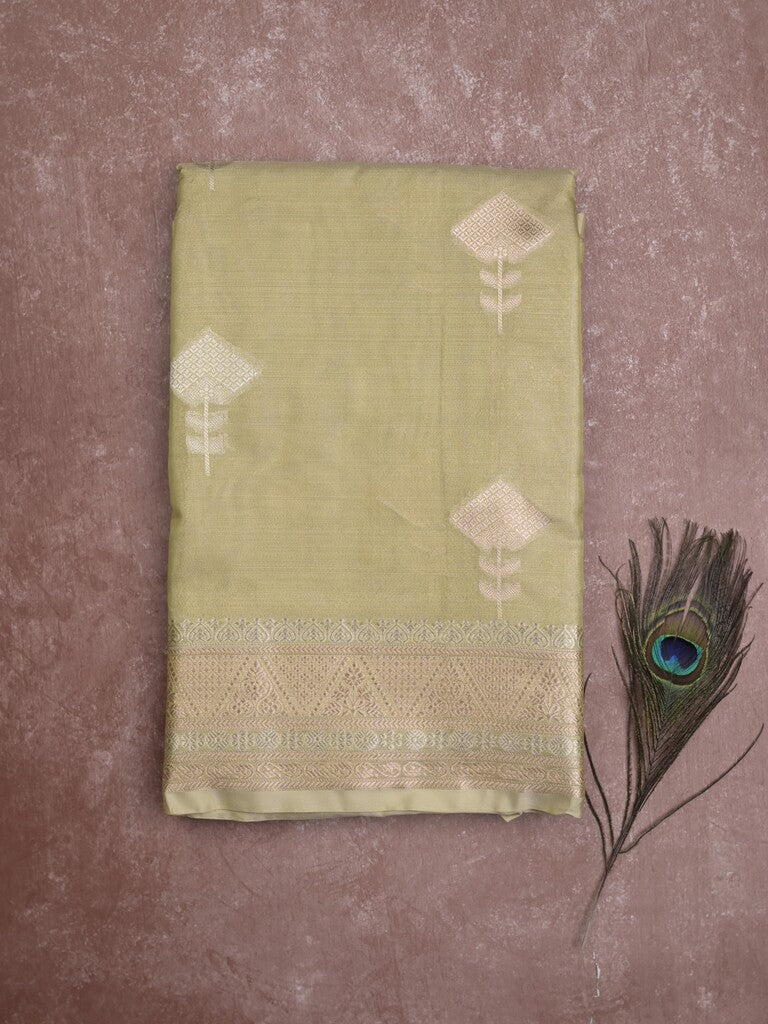 Fancy tissue saree in light green color allover zari motifs & zari border with zari pallu and self blouse