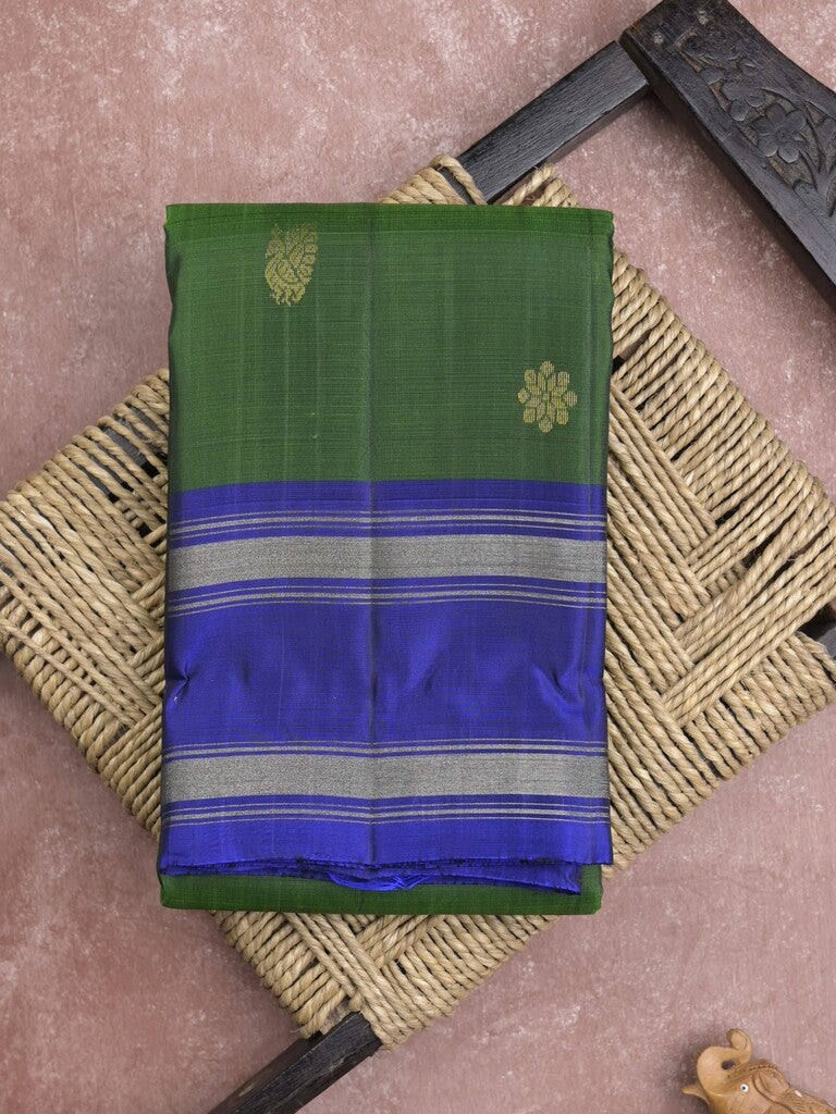 Kanchi pattu saree in bottle green color allover zari motifs & zari border with rich pallu and plain blouse