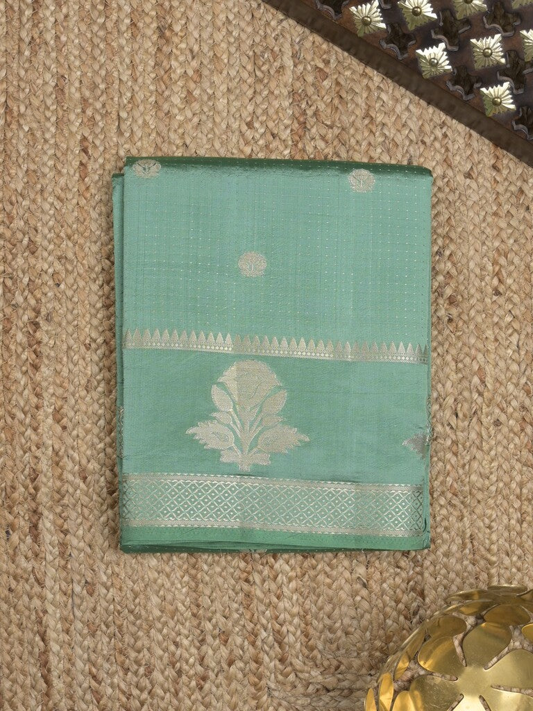 Dupion fancy saree in lux green color allover zari motifs & zari border with zari pallu and attached blouse