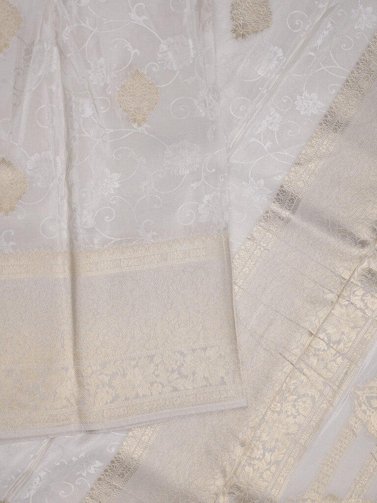 Dola tissue fancy saree white color allover zari motifs & zari border with rich pallu and plain self blouse