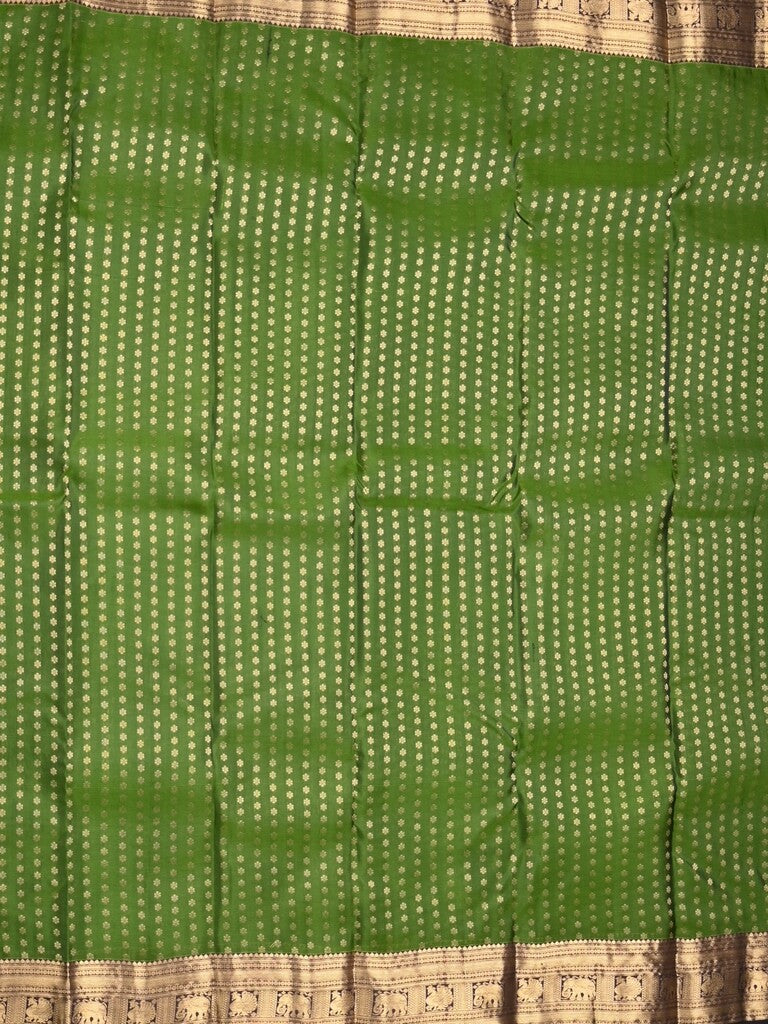 Kanchi pattu saree bottle green color allover zari motifs & zari border with rich pallu and contrast plain blouse