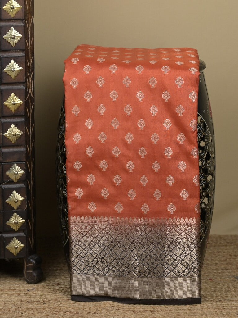 Dupion fancy saree in rust orange color allover zari motifs & zari border with zari pallu and contrast blouse