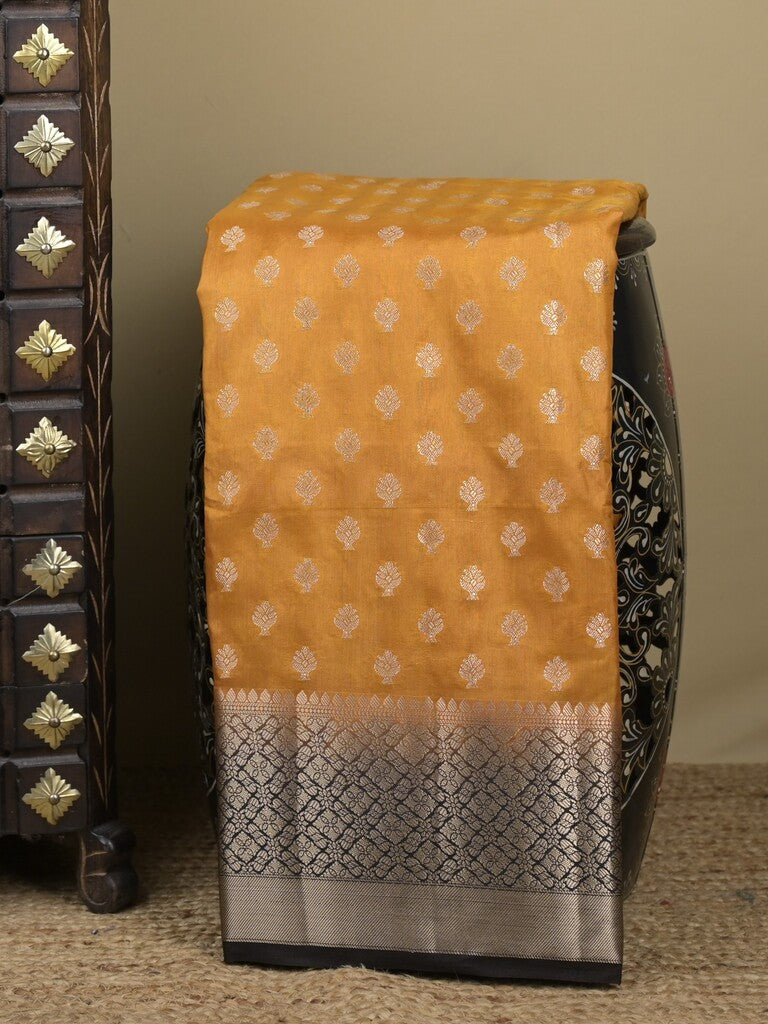 Dupion fancy saree in mustard yellow color allover zari motifs & zari border with zari pallu and contrast blouse