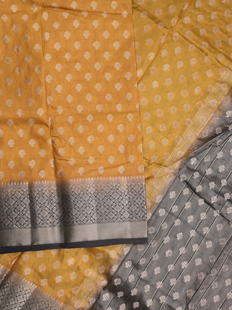 Dupion fancy saree in mustard yellow color allover zari motifs & zari border with zari pallu and contrast blouse