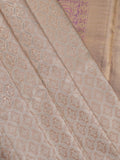 Traditional bridal kanchi tissue pattu saree in cream color with allover rich zari weaves