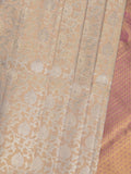 Traditional bridal kanchi tissue pattu saree in cream color with allover rich zari weaves
