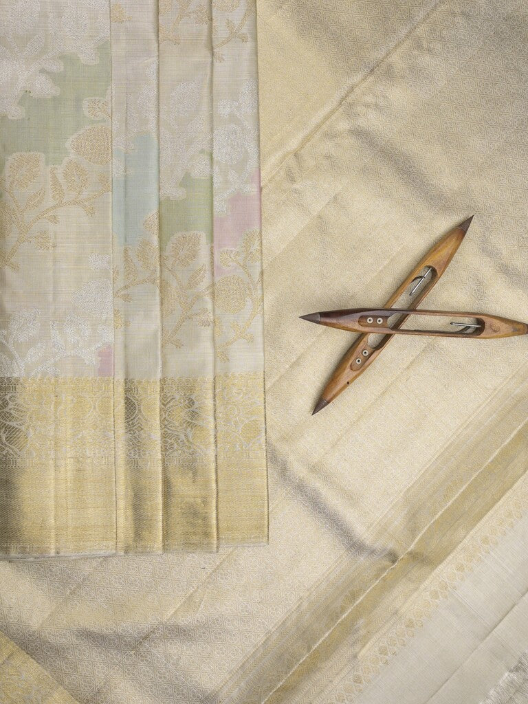 Traditional bridal kanchi tissue pattu saree in cream color with allover rich zari weaves
