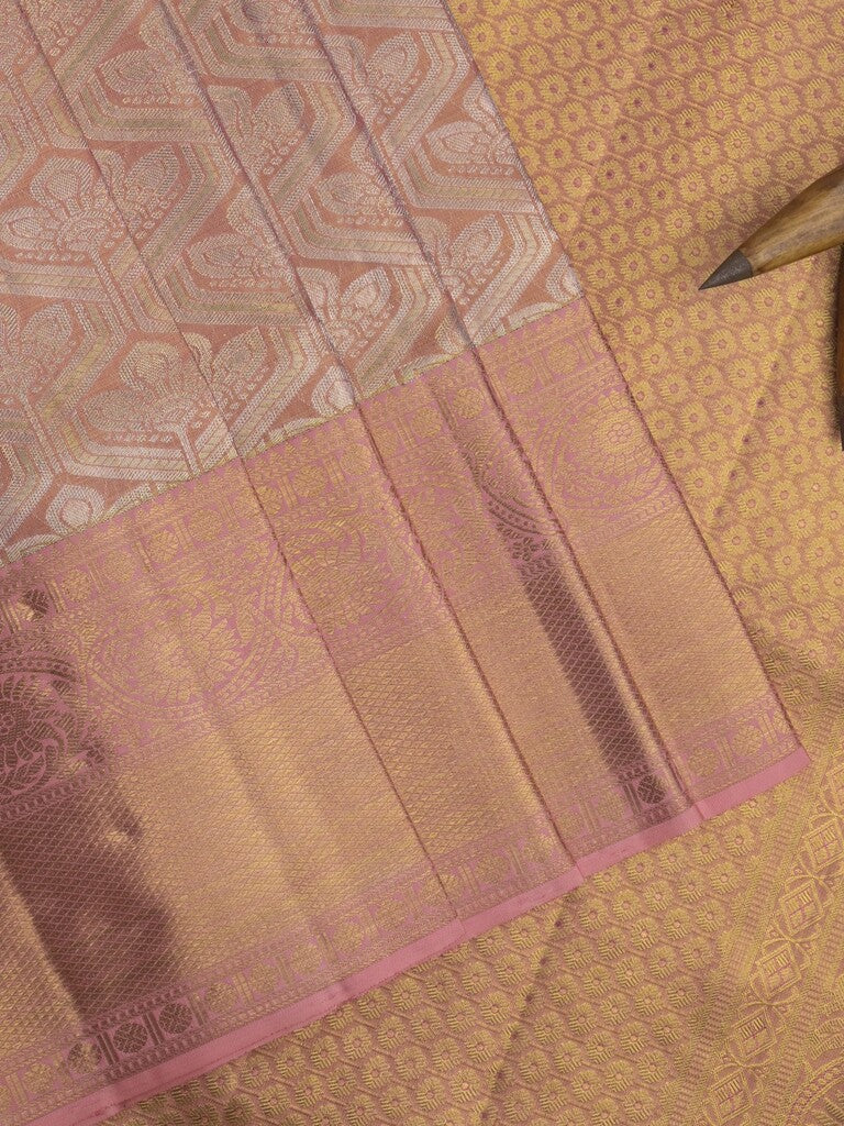 Traditional bridal kanchi tissue pattu saree in peach color with allover rich zari weaves