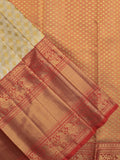 Traditional bridal kanchi tissue pattu saree in cream color with allover rich zari weaves