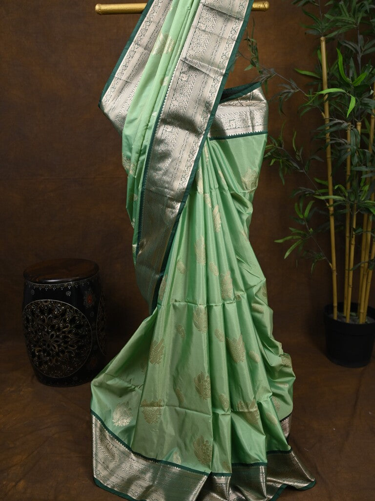 Kanchi pattu saree pista green color allover zari weaves & kanchi border with rich pallu and contrast plain blouse
