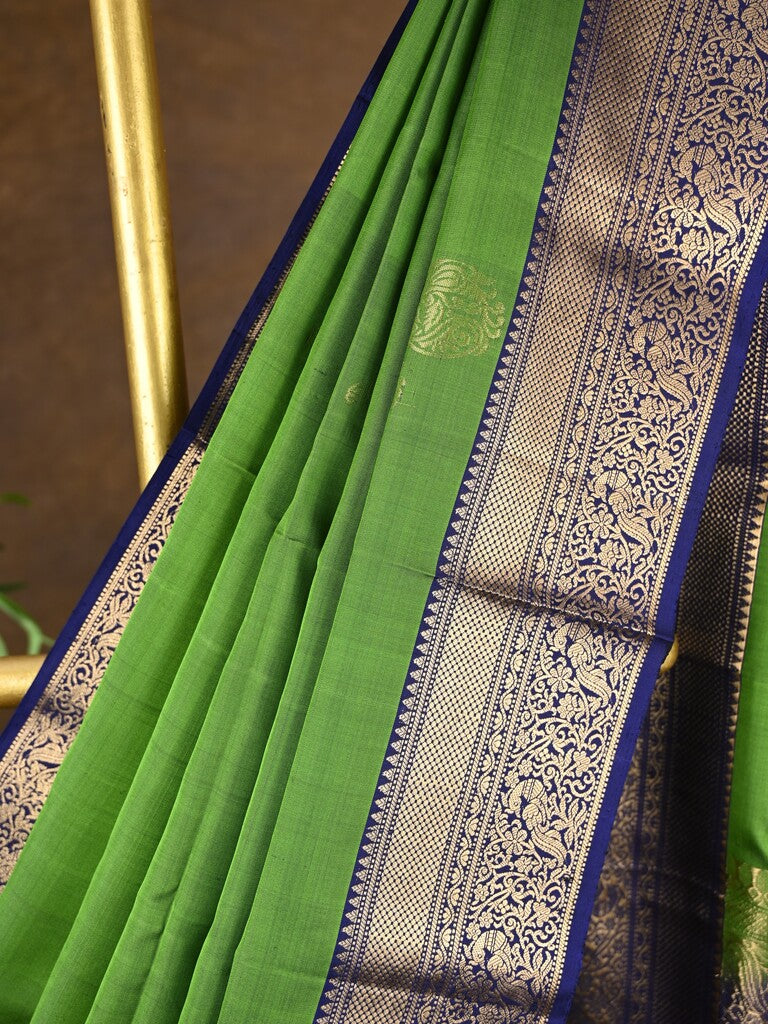 Kanchi pattu saree parrot green color allover zari motifs & zari border with rich pallu and contrast plain blouse