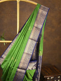 Kanchi pattu saree parrot green color allover zari motifs & zari border with rich pallu and contrast plain blouse