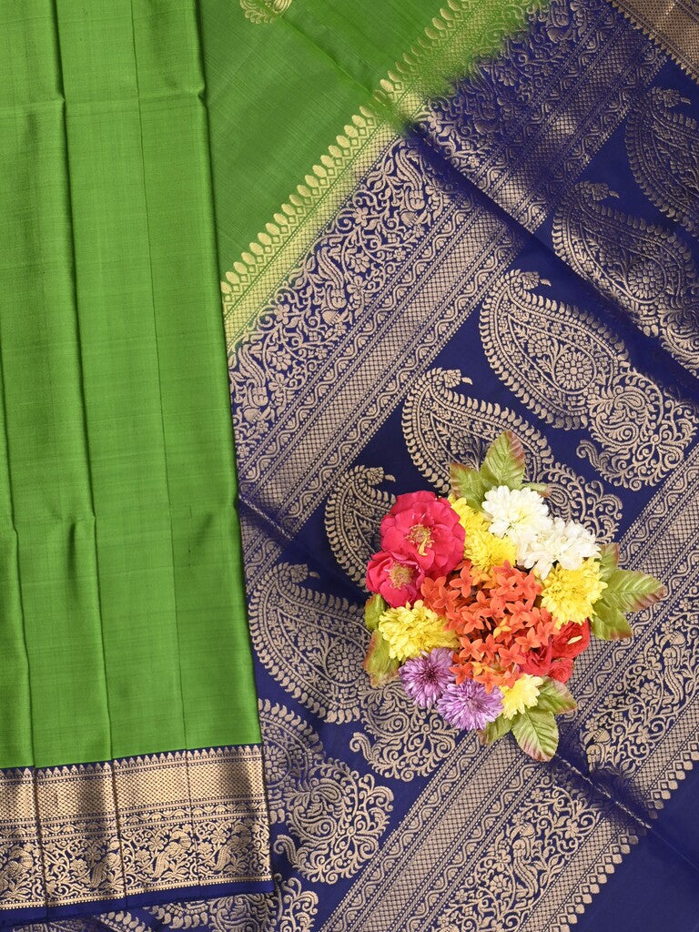 Kanchi pattu saree parrot green color allover zari motifs & zari border with rich pallu and contrast plain blouse
