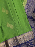 Kanchi pattu saree parrot green color allover zari motifs & zari border with rich pallu and contrast plain blouse