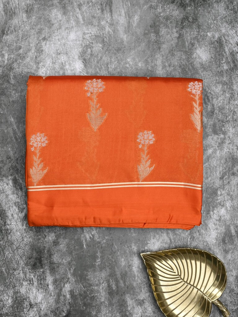 Raw mango fancy saree orange color allover zari motifs & zari border with zari pallu and attached self blouse