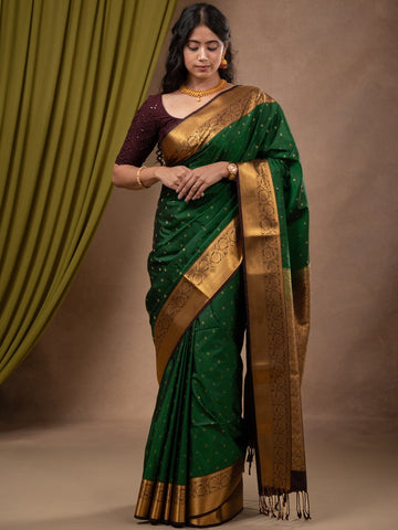 Kanchi pattu saree bottle green color allover zari motifs & zari border with rich pallu and contrast plain blouse