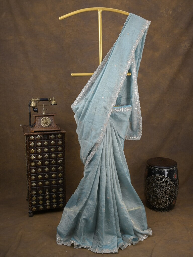 Tissue crush fancy saree light blue color allover motifs & embroidery border with running pallu and printed blouse