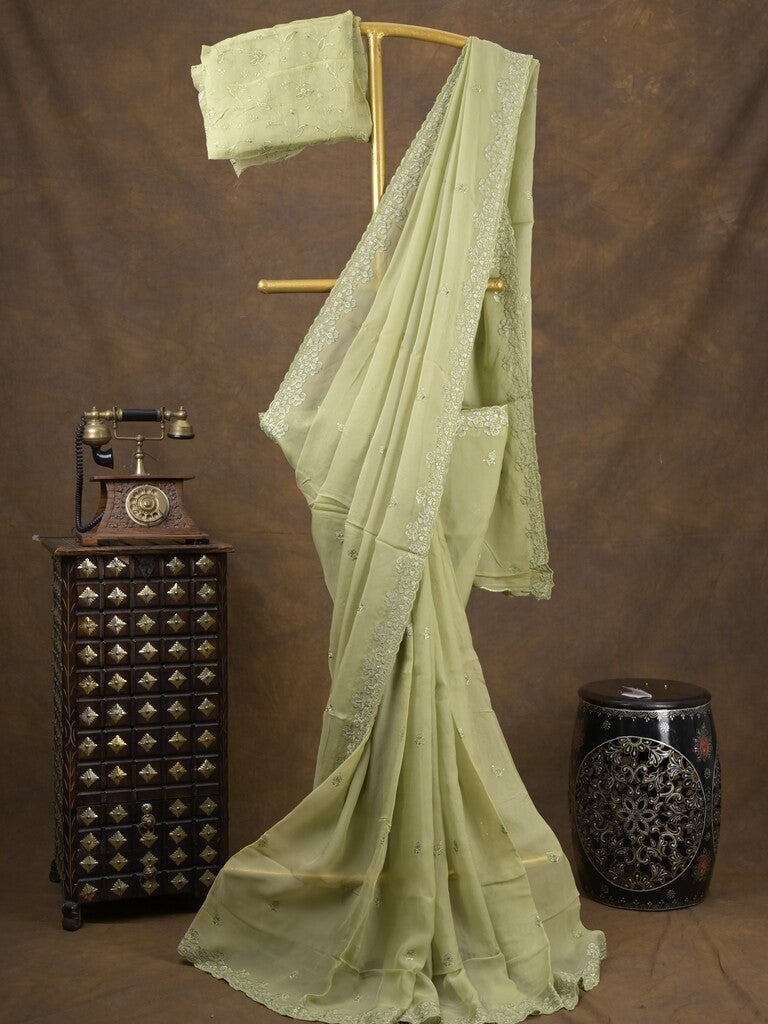 Organza fancy saree light pastel green color allover embroidered motifs & cutwork border with running pallu and self blouse
