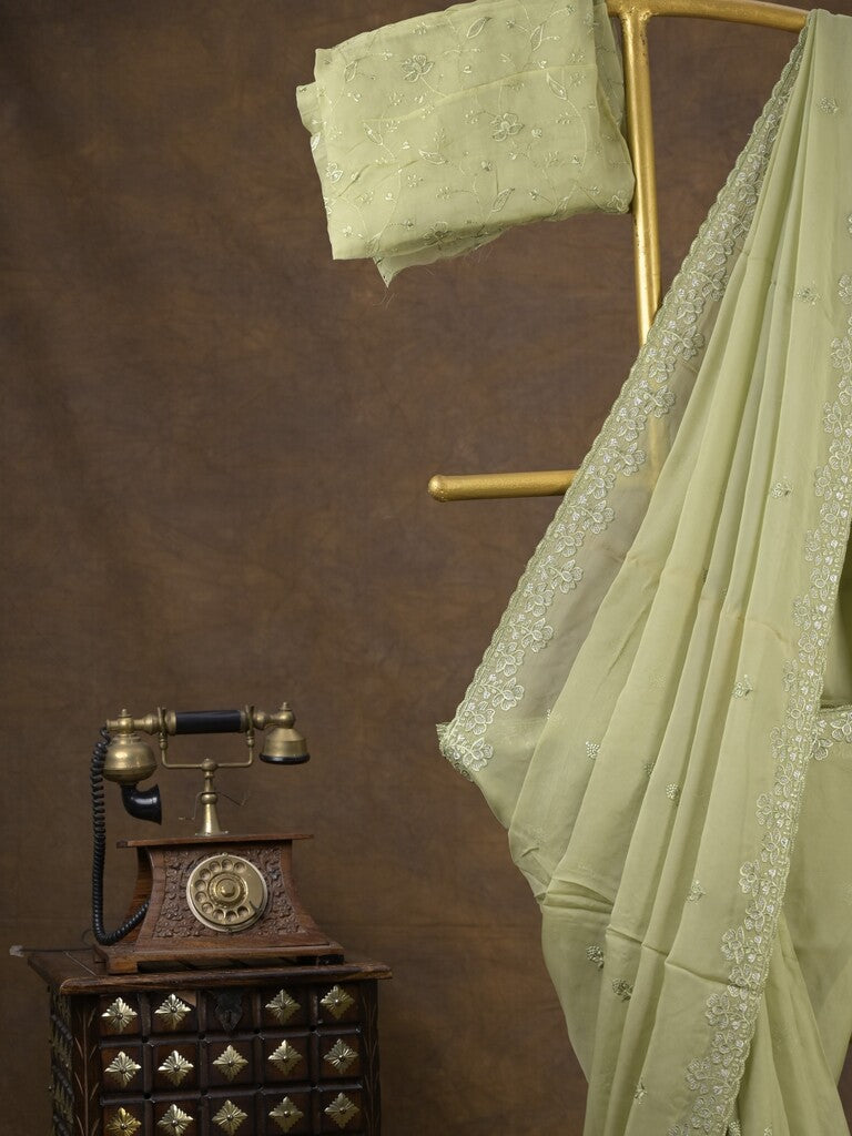 Organza fancy saree light pastel green color allover embroidered motifs & cutwork border with running pallu and self blouse