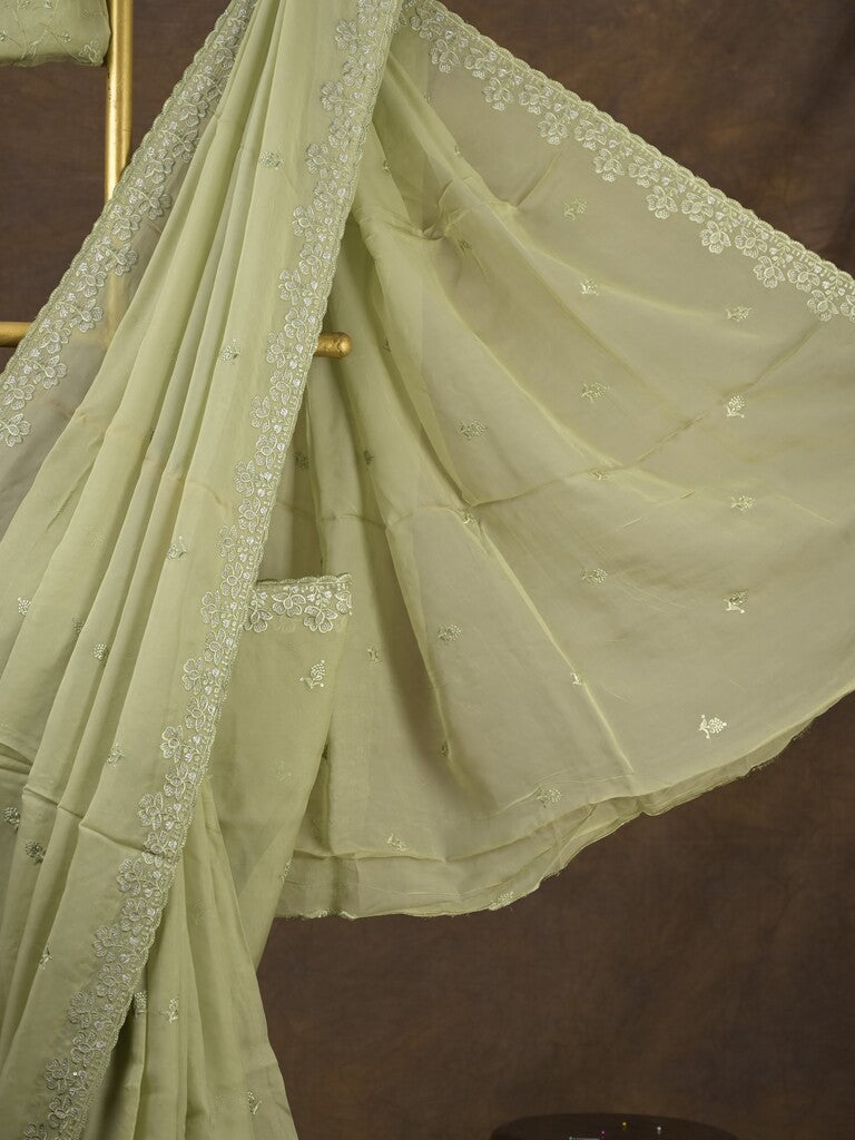 Organza fancy saree light pastel green color allover embroidered motifs & cutwork border with running pallu and self blouse