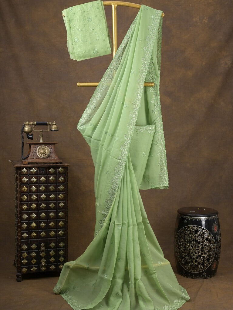 Organza fancy saree light pista green color allover embroidered motifs & cutwork border with running pallu and self blouse