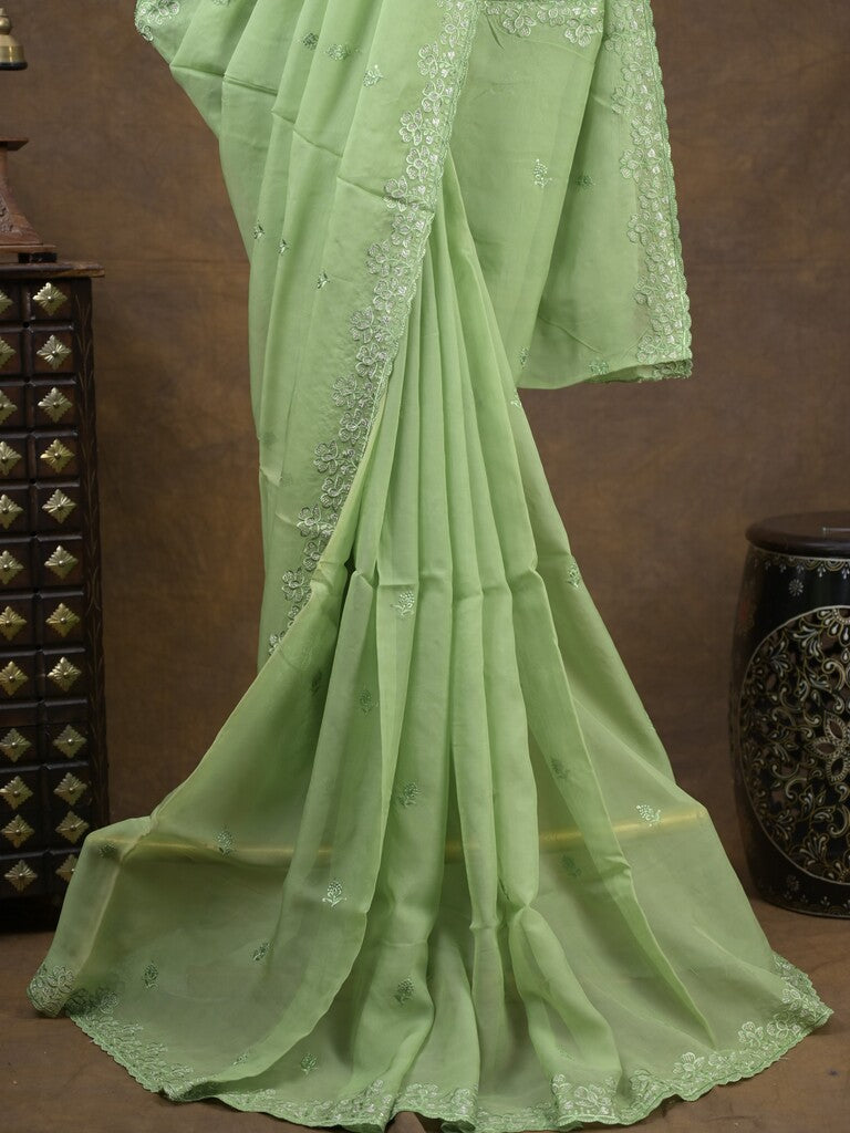 Organza fancy saree light pista green color allover embroidered motifs & cutwork border with running pallu and self blouse