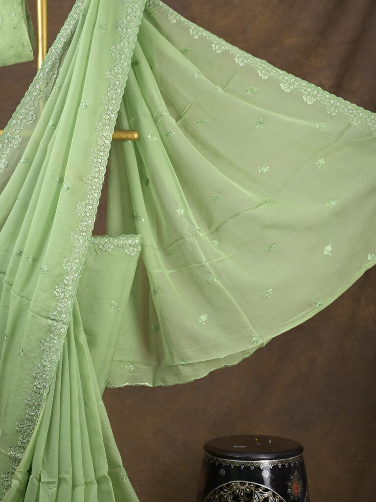 Organza fancy saree light pista green color allover embroidered motifs & cutwork border with running pallu and self blouse