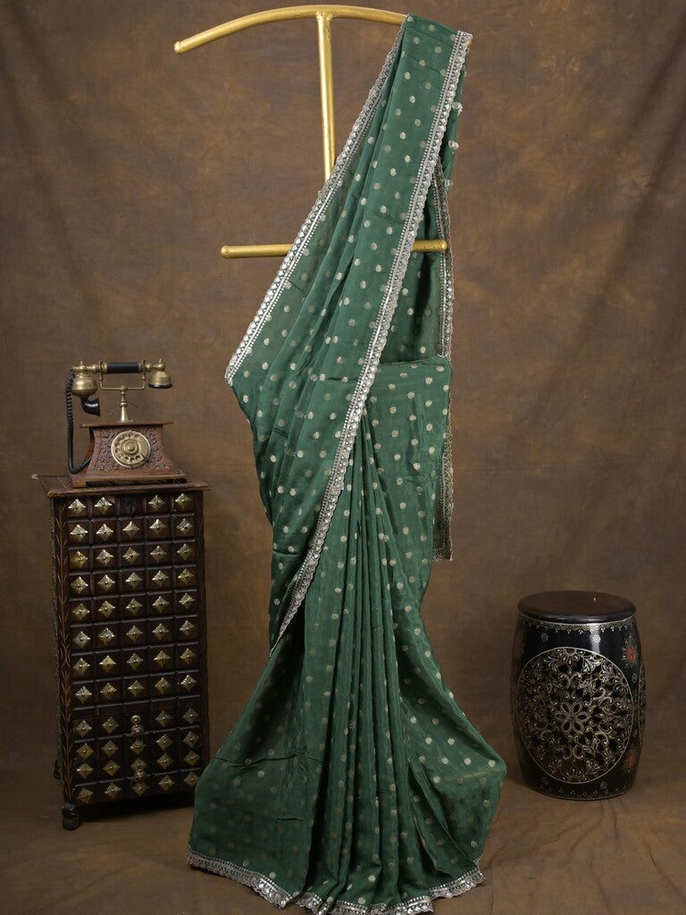 Chinnon fancy saree dark green color allover motifs & embroidery border with running pallu and contrast blouse