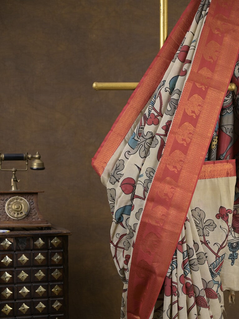 Pen kalamkari pattu cream color floral painted saree with contrast zari border and printed pallu & attached blouse