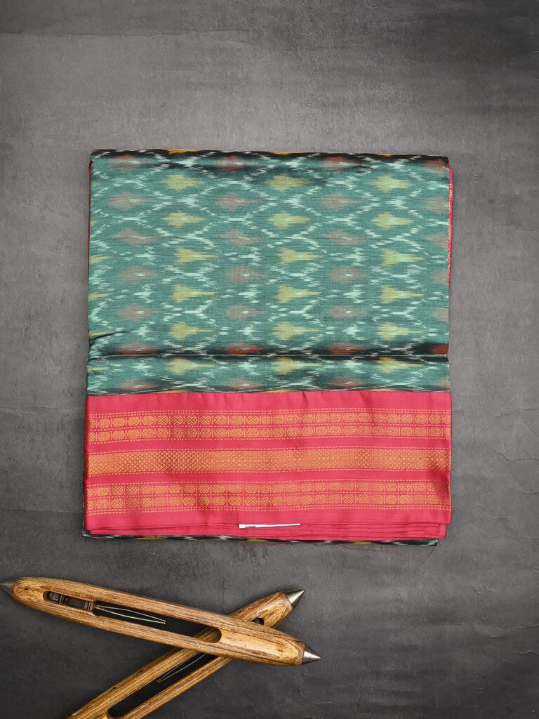 Ikkat pattu saree peacock green color allover weaves & zari border with contrast pallu and contrast blouse