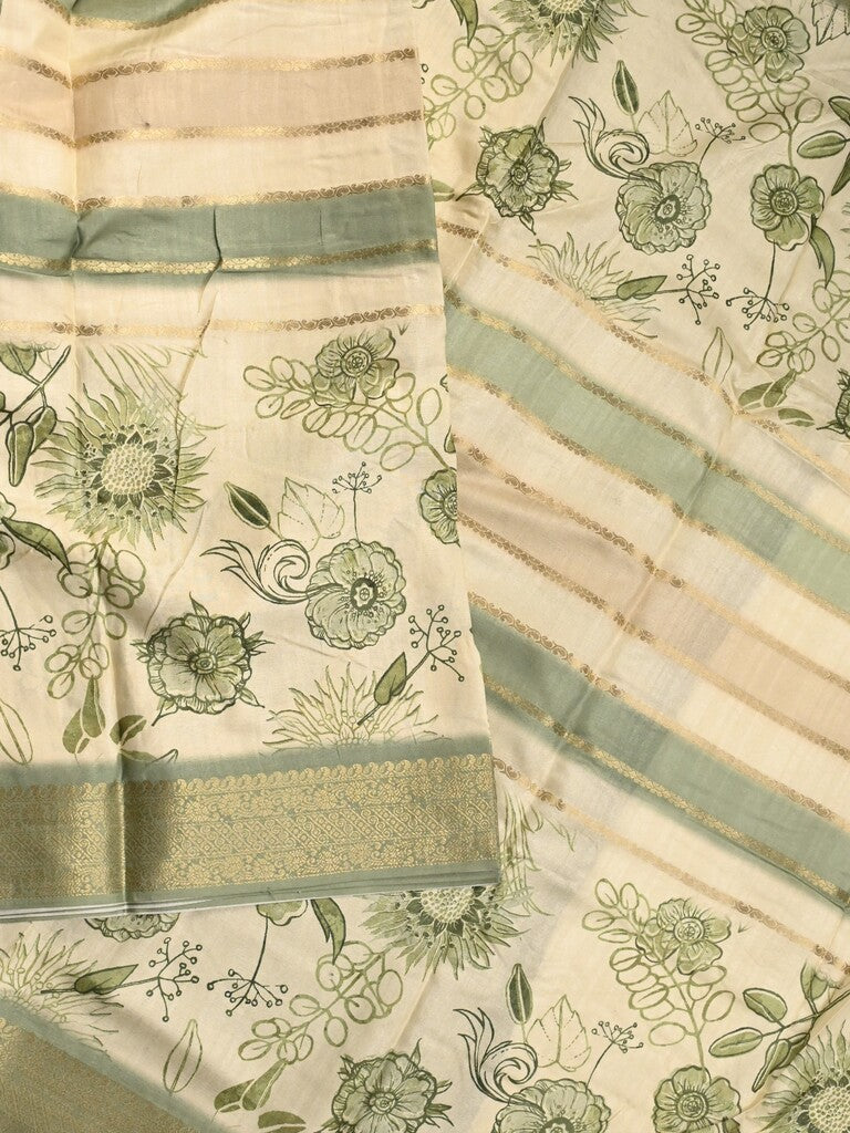 Dola silk fancy saree cream and green color allover prints & zari border with printed pallu and printed blouse