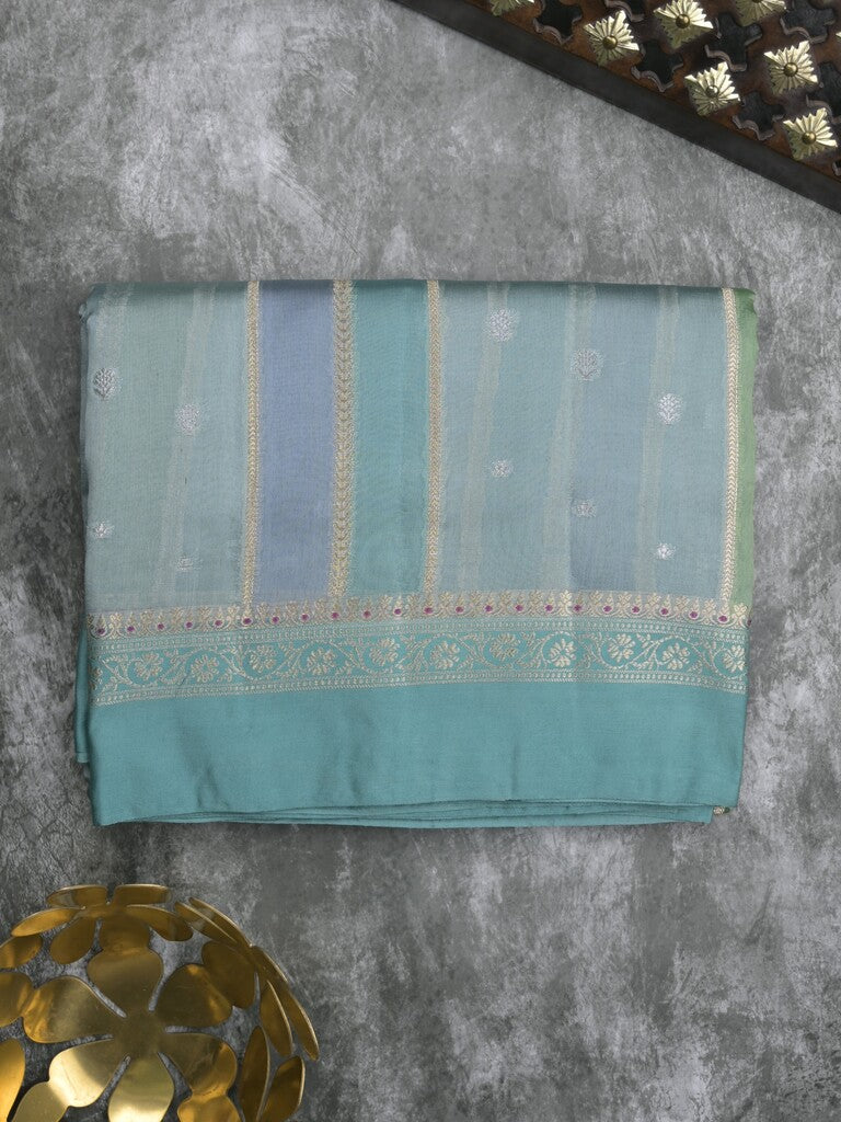 Raw mango fancy saree in light blue color with allover zari weaves and zari border with brocade pallu & blouse